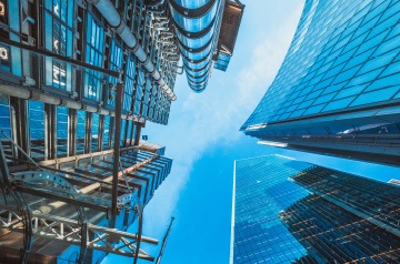 Looking skyward along glass fronted skyscrapers