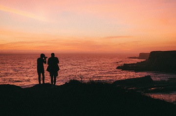 taking photos of coastline at dusk
