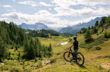 cyclist resting, mountains behind