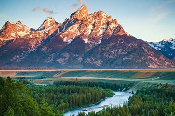 scenic lake view at sunset, mountains behind