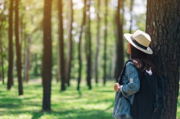 standing in sunny forest