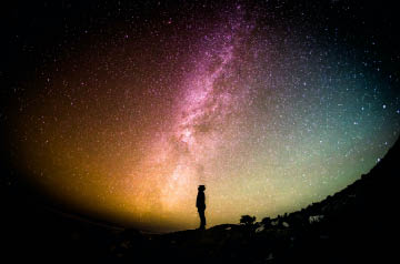 person looking up at starry sky